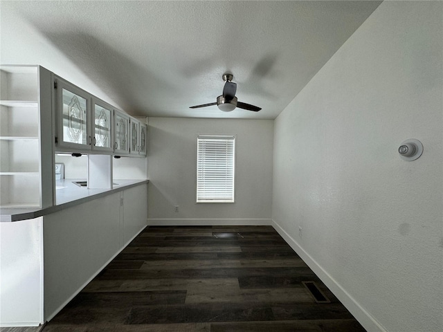 181A-B Beacon Hill Dr, Longview, WA 98632 - unfurnished dining area featuring ceiling fan, baseboards, dark wood-type flooring, and a textured ceiling