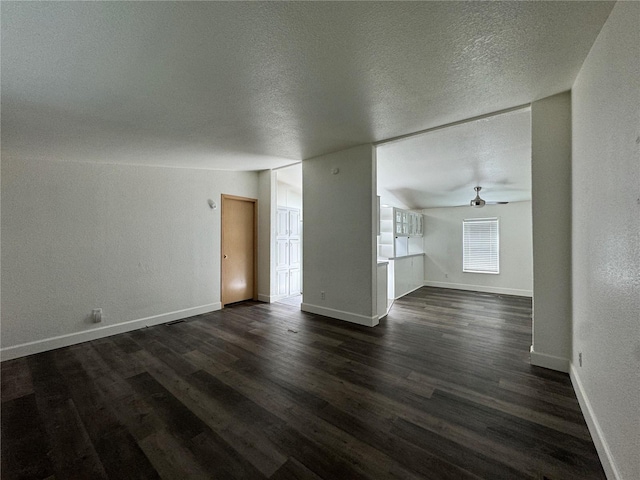 181A-B Beacon Hill Dr, Longview, WA 98632 - unfurnished living room with dark wood-style flooring, ceiling fan, a textured ceiling, and baseboards