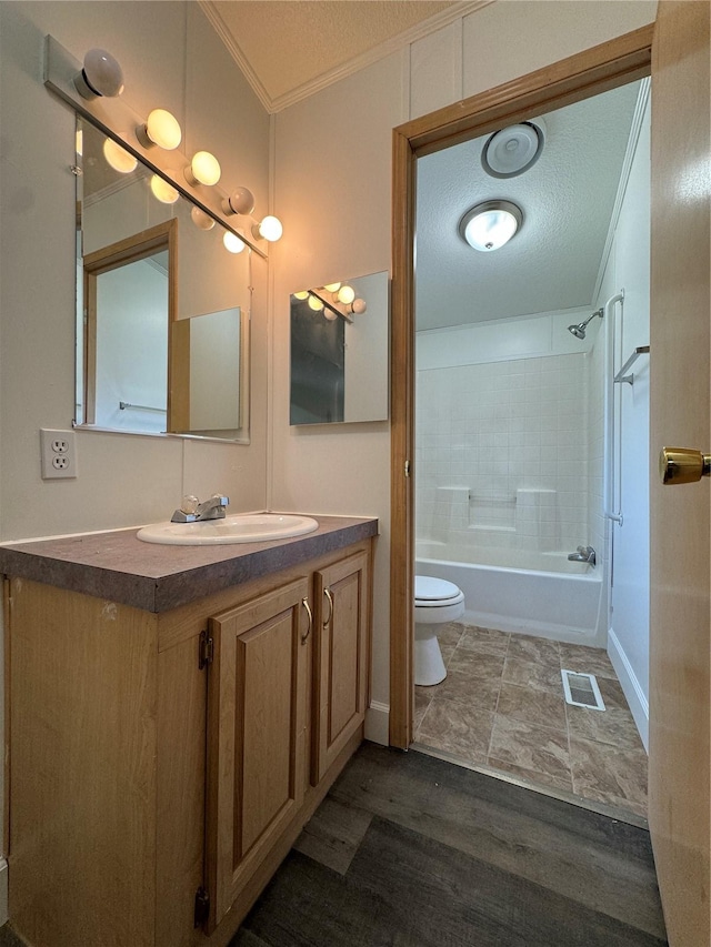181A-B Beacon Hill Dr, Longview, WA 98632 - bathroom featuring crown molding, toilet, vanity, wood finished floors, and bathing tub / shower combination