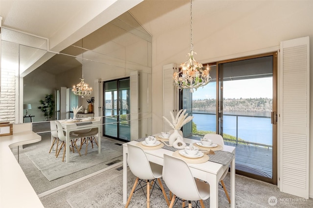 dining room with an inviting chandelier, a water view, and a wealth of natural light