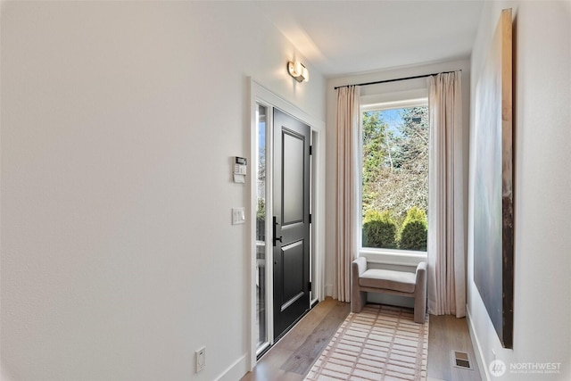 doorway featuring visible vents and light wood finished floors