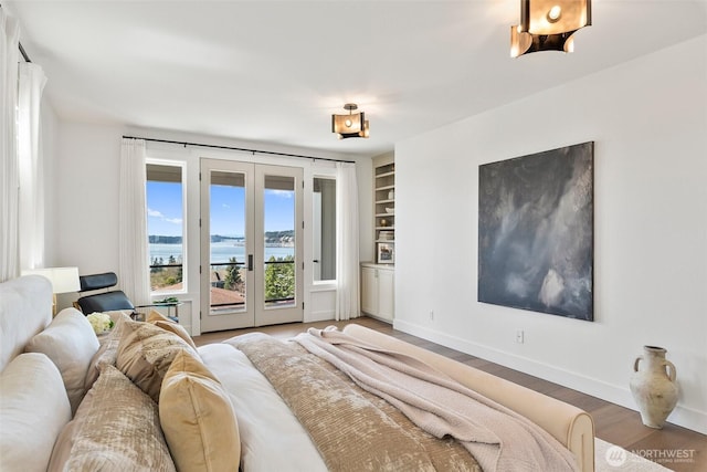 bedroom with baseboards, light wood-style flooring, french doors, and access to outside