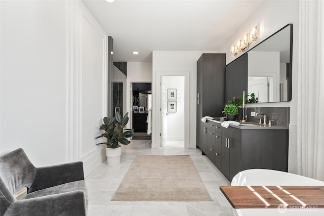 full bathroom with a sink, recessed lighting, and double vanity