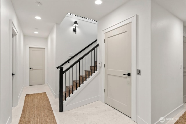 staircase featuring baseboards and recessed lighting