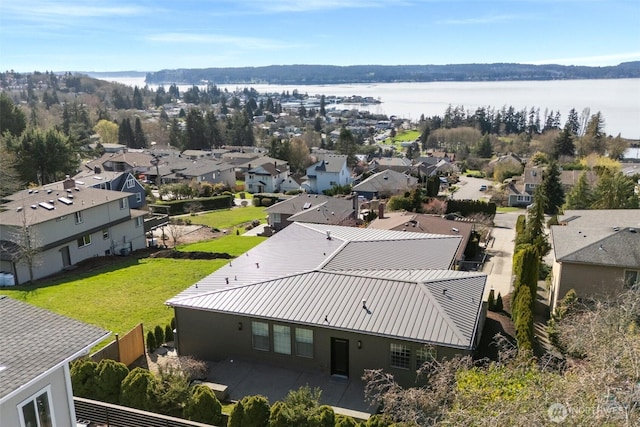 drone / aerial view with a residential view and a water view