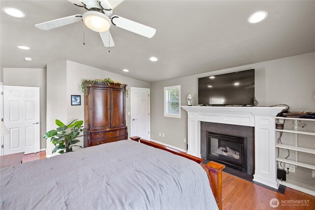 bedroom featuring lofted ceiling, wood finished floors, and recessed lighting