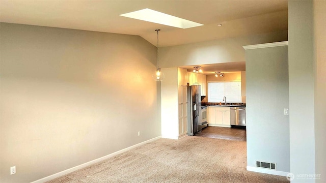 485 SW Bayshore Dr Unit C301, Oak Harbor, WA 98277 - spare room with visible vents, dark colored carpet, a sink, baseboards, and lofted ceiling with skylight