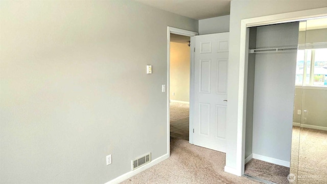 485 SW Bayshore Dr Unit C301, Oak Harbor, WA 98277 - unfurnished bedroom with a closet, carpet flooring, baseboards, and visible vents