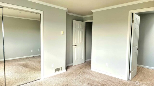 485 SW Bayshore Dr Unit C301, Oak Harbor, WA 98277 - unfurnished bedroom with a closet, baseboards, ornamental molding, visible vents, and carpet