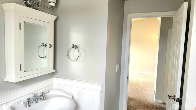 485 SW Bayshore Dr Unit C301, Oak Harbor, WA 98277 - bathroom featuring a sink and a wainscoted wall