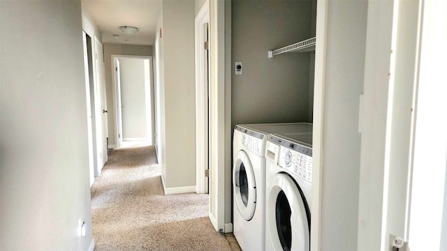 485 SW Bayshore Dr Unit C301, Oak Harbor, WA 98277 - washroom featuring baseboards, washing machine and dryer, and carpet floors