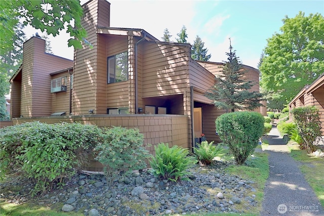 11500 NE 128th St Unit 48, Kirkland, WA 98034 - view of home's exterior featuring a chimney