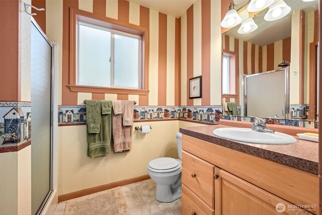full bath featuring wallpapered walls, a stall shower, toilet, and vanity