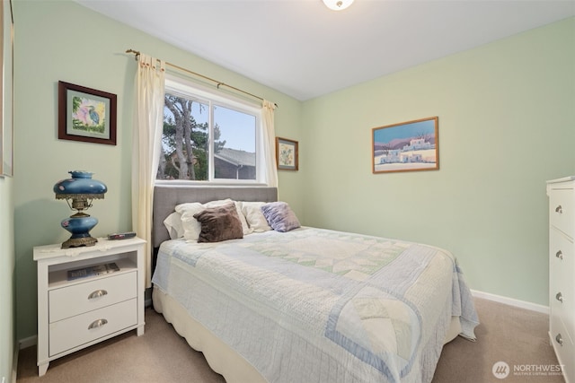 carpeted bedroom featuring baseboards