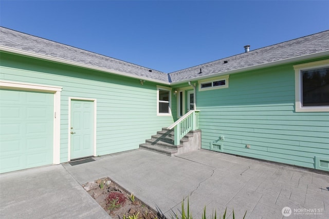 305 W Eunice St, Sequim, WA 98382 - property entrance with a patio, a garage, and roof with shingles