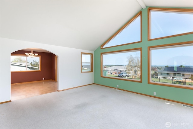 305 W Eunice St, Sequim, WA 98382 - carpeted spare room featuring a chandelier, visible vents, vaulted ceiling, baseboards, and arched walkways