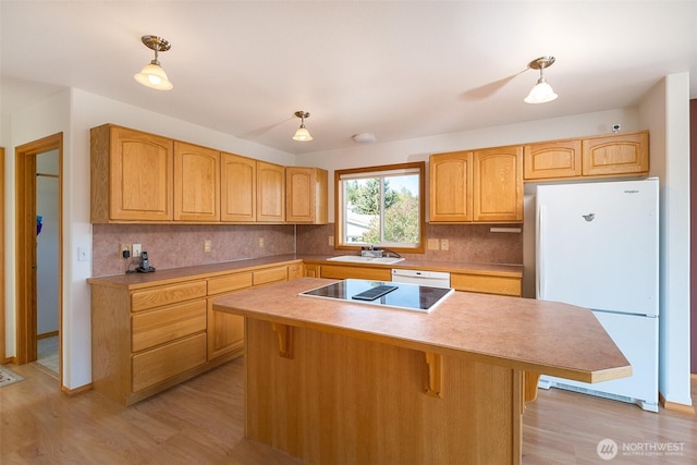305 W Eunice St, Sequim, WA 98382 - kitchen with light wood-type flooring, decorative light fixtures, backsplash, and white appliances