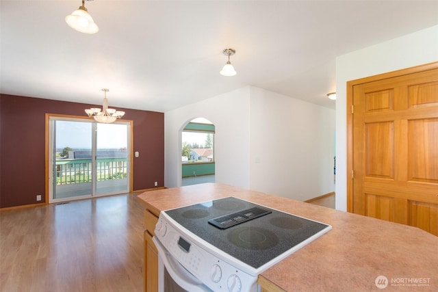 305 W Eunice St, Sequim, WA 98382 - kitchen with range with electric cooktop, a notable chandelier, light wood-type flooring, hanging light fixtures, and open floor plan
