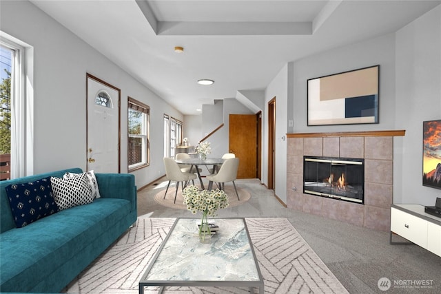 living area with a fireplace and carpet