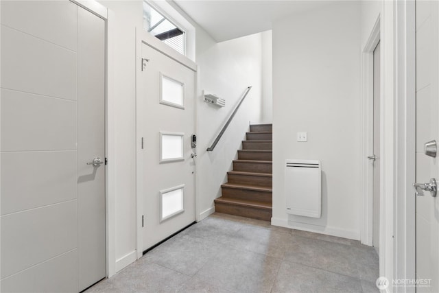 2620 SW Nevada St, Seattle, WA 98126 - entryway featuring heating unit, baseboards, and stairs