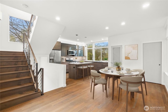 2620 SW Nevada St, Seattle, WA 98126 - dining area featuring recessed lighting, light wood-type flooring, and stairs