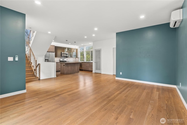 2620 SW Nevada St, Seattle, WA 98126 - unfurnished living room featuring baseboards, recessed lighting, and a wall mounted AC