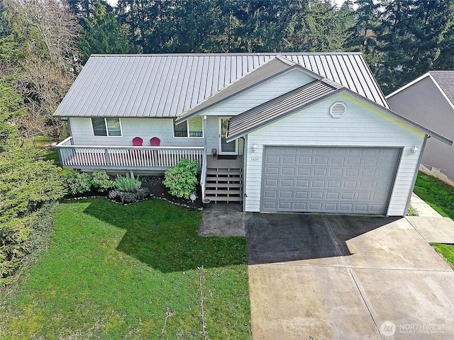 1637 Poplar Ln, Camano Island, WA 98282 - view of front of property with a front lawn, a garage, metal roof, driveway, and a deck