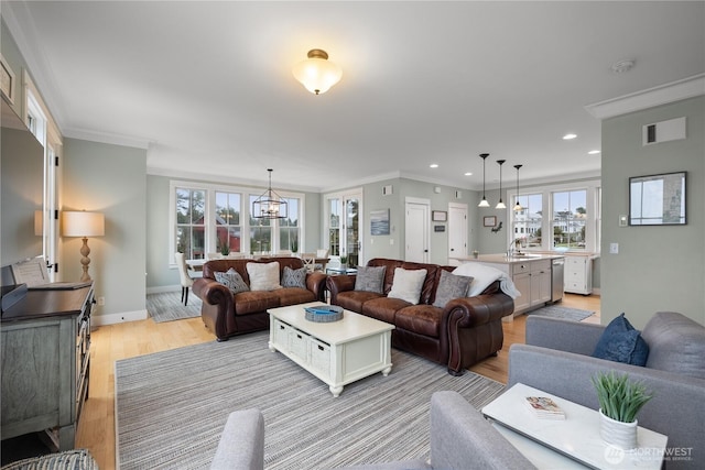78 Pacifica Ln, Pacific Beach, WA 98571 - living area with baseboards, ornamental molding, a wealth of natural light, and light wood finished floors