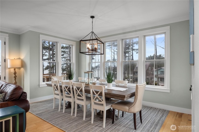 78 Pacifica Ln, Pacific Beach, WA 98571 - dining space featuring baseboards, light wood-style flooring, ornamental molding, and a chandelier