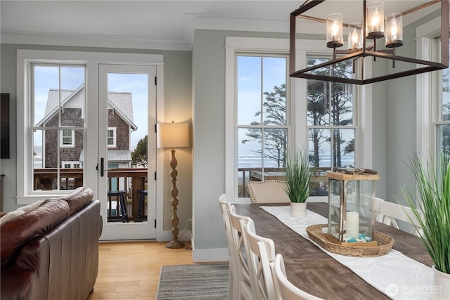 78 Pacifica Ln, Pacific Beach, WA 98571 - dining room with light wood finished floors, baseboards, ornamental molding, and an inviting chandelier