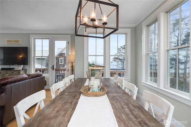 78 Pacifica Ln, Pacific Beach, WA 98571 - dining space featuring a notable chandelier, crown molding, and wood finished floors