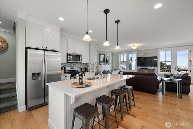 78 Pacifica Ln, Pacific Beach, WA 98571 - kitchen with decorative backsplash, crown molding, a kitchen bar, stainless steel appliances, and a sink