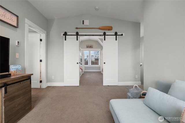 78 Pacifica Ln, Pacific Beach, WA 98571 - interior space featuring lofted ceiling, a barn door, visible vents, and carpet