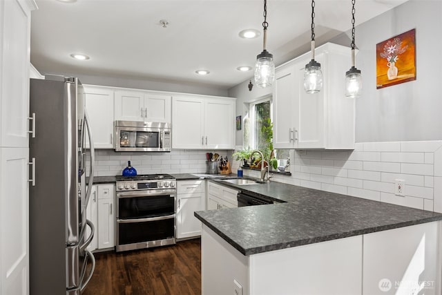 31000 186th Pl SE, Covington, WA 98042 - kitchen featuring dark wood-style flooring, a sink, white cabinets, a peninsula, and appliances with stainless steel finishes