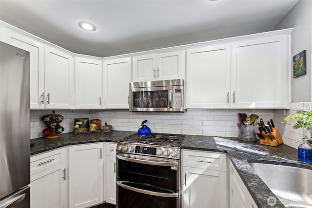 31000 186th Pl SE, Covington, WA 98042 - kitchen with a sink, backsplash, white cabinetry, appliances with stainless steel finishes, and dark stone countertops