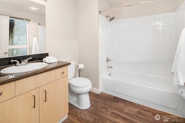 108 5th Ave S Unit 520, Seattle, WA 98104 - bathroom featuring wood finished floors, toilet, shower / bathing tub combination, and vanity