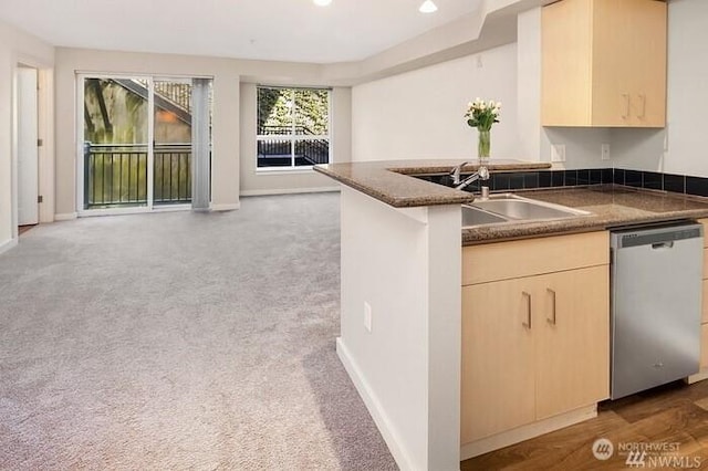 108 5th Ave S Unit 520, Seattle, WA 98104 - kitchen with dishwasher, open floor plan, a sink, and dark countertops