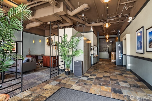 108 5th Ave S Unit 520, Seattle, WA 98104 - interior space featuring a high ceiling, stone finish flooring, and baseboards