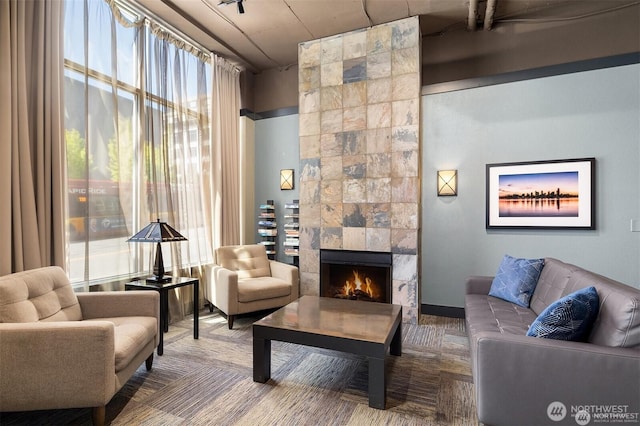 108 5th Ave S Unit 520, Seattle, WA 98104 - living area featuring a tile fireplace, carpet, and a healthy amount of sunlight