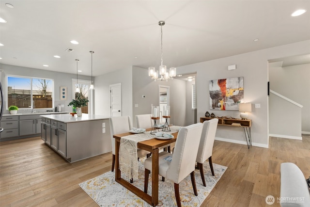 dining space with visible vents, baseboards, a notable chandelier, light wood-type flooring, and recessed lighting