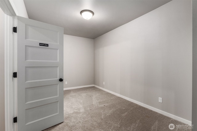 carpeted empty room with baseboards