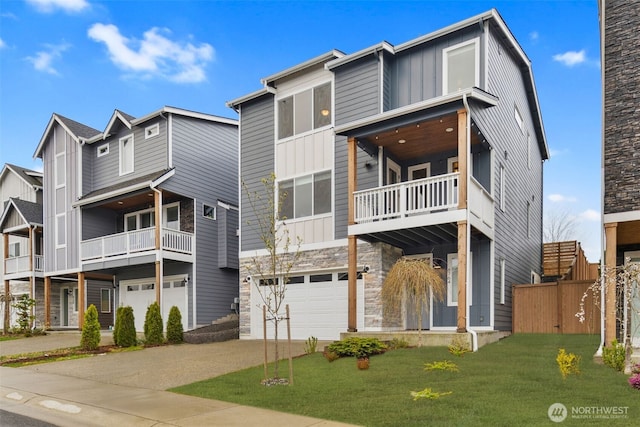 view of front facade with driveway, stone siding, an attached garage, a balcony, and board and batten siding
