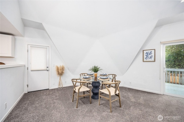 6455 NE Brigham Rd, Bainbridge Island, WA 98110 - dining space featuring dark colored carpet, lofted ceiling, and baseboards