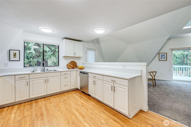 6455 NE Brigham Rd, Bainbridge Island, WA 98110 - kitchen with stainless steel dishwasher, a sink, light countertops, white cabinets, and a peninsula