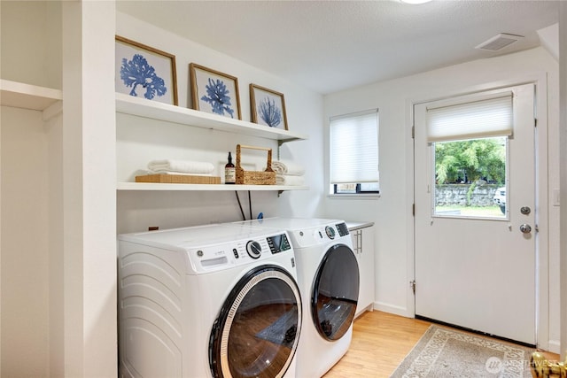 6455 NE Brigham Rd, Bainbridge Island, WA 98110 - laundry room with separate washer and dryer, light wood finished floors, baseboards, and cabinet space