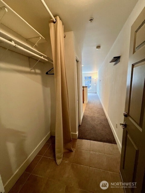 123 Queen Anne Ave N Unit 405, Seattle, WA 98109 - hallway featuring carpet floors, baseboards, and tile patterned floors