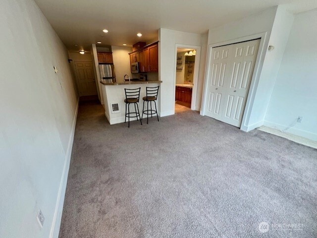 123 Queen Anne Ave N Unit 405, Seattle, WA 98109 - living room featuring light colored carpet, baseboards, and recessed lighting