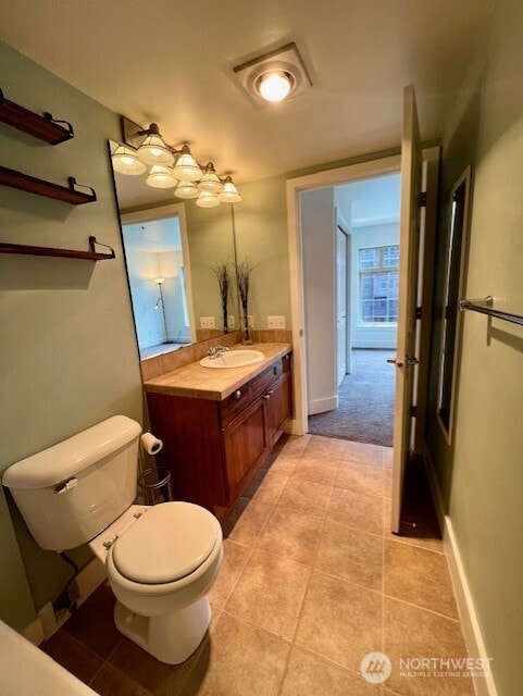 123 Queen Anne Ave N Unit 405, Seattle, WA 98109 - bathroom with toilet, baseboards, tile patterned floors, and vanity