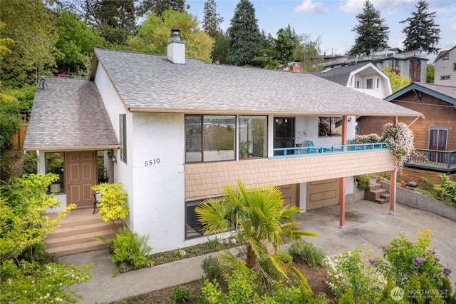 5510 3rd Ave NW, Seattle, WA 98107 - view of front of property featuring a chimney, roof with shingles, an attached garage, stucco siding, and driveway