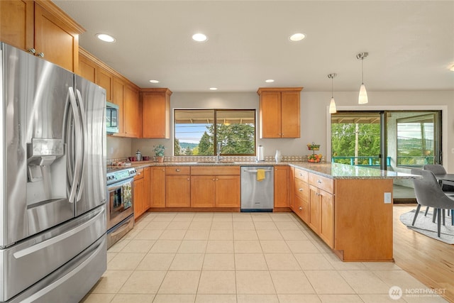5510 3rd Ave NW, Seattle, WA 98107 - kitchen featuring stainless steel appliances, a peninsula, plenty of natural light, a sink, and recessed lighting